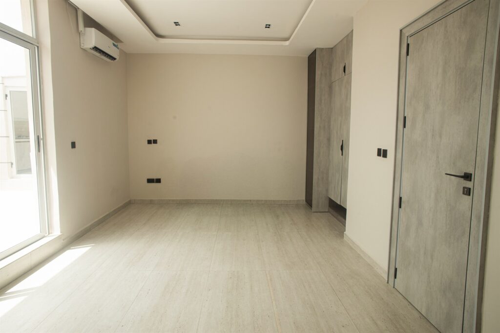Brum Height 6: Unfurnished bedroom with a large window and fitted wardrobe